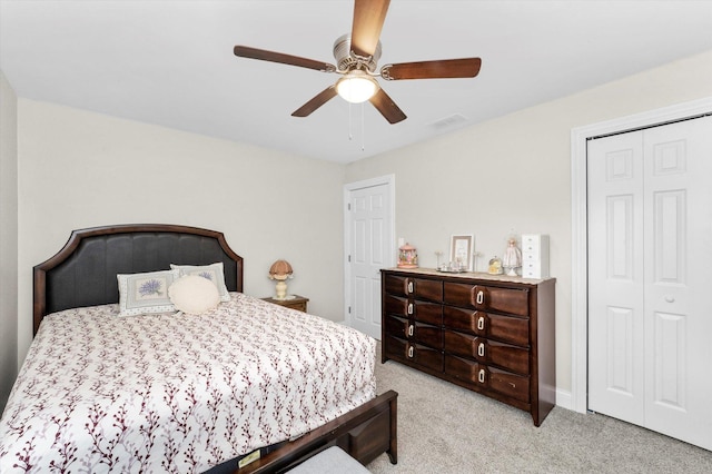 carpeted bedroom featuring ceiling fan and a closet