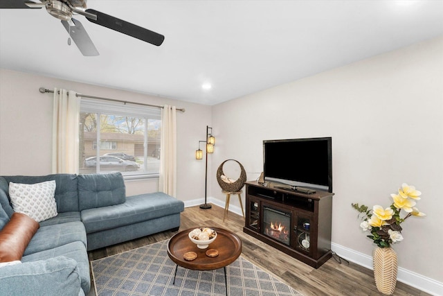 living room with wood-type flooring and ceiling fan