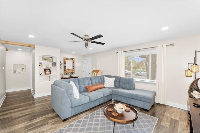 living room with dark hardwood / wood-style flooring and ceiling fan