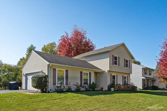 view of front of property featuring a garage and a front yard