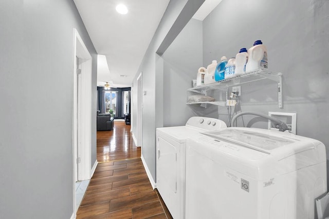 clothes washing area with laundry area, ceiling fan, wood finished floors, washer and dryer, and baseboards