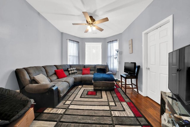 living room with baseboards, a ceiling fan, and wood finished floors