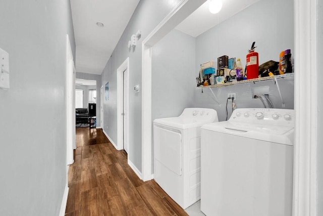 laundry room featuring washer and dryer, wood finished floors, and baseboards