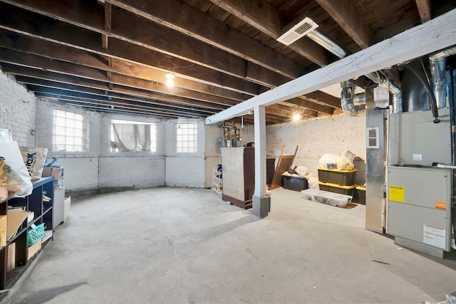 basement with visible vents and heating unit