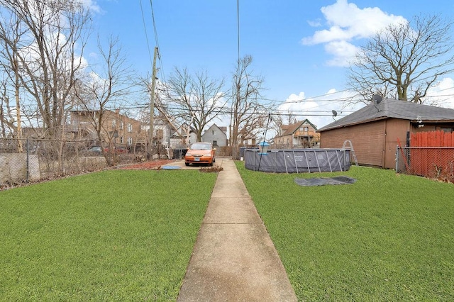view of yard featuring an outdoor pool and a fenced backyard