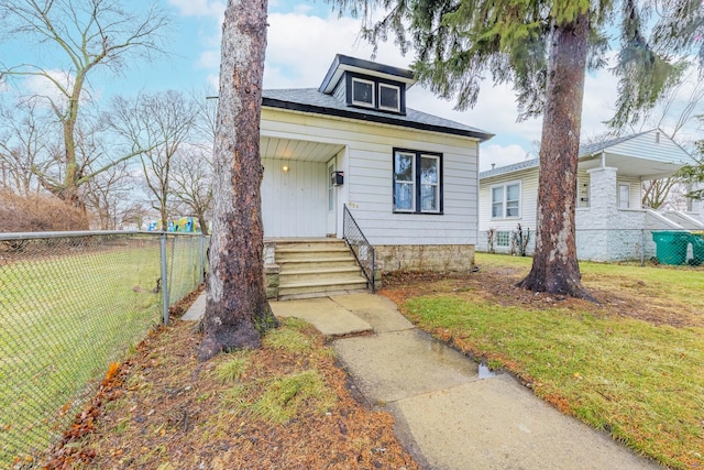 bungalow-style house with a front lawn