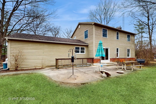 back of property with a patio and a yard