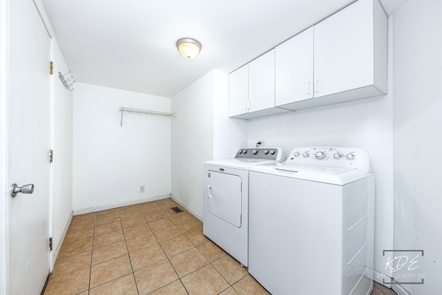 washroom with cabinets, light tile patterned floors, and independent washer and dryer