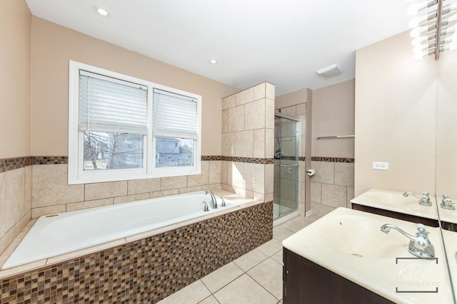 bathroom featuring vanity, tile patterned floors, and plus walk in shower