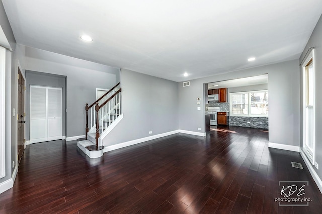 unfurnished living room featuring dark wood-type flooring