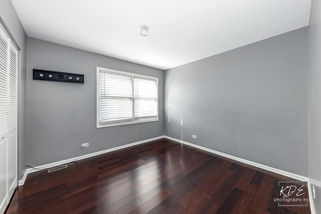 unfurnished room with hardwood / wood-style floors