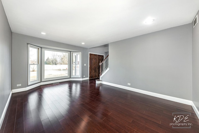 spare room with dark hardwood / wood-style flooring