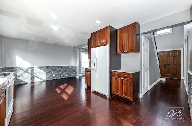 kitchen with white appliances and dark hardwood / wood-style floors