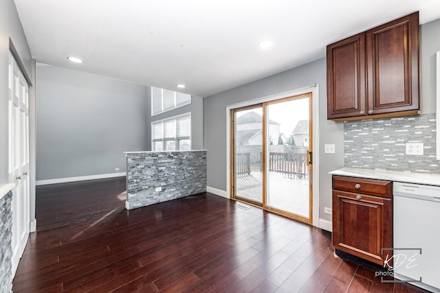 kitchen featuring tasteful backsplash, dark wood-type flooring, and white dishwasher