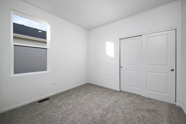 unfurnished bedroom with carpet floors and a closet