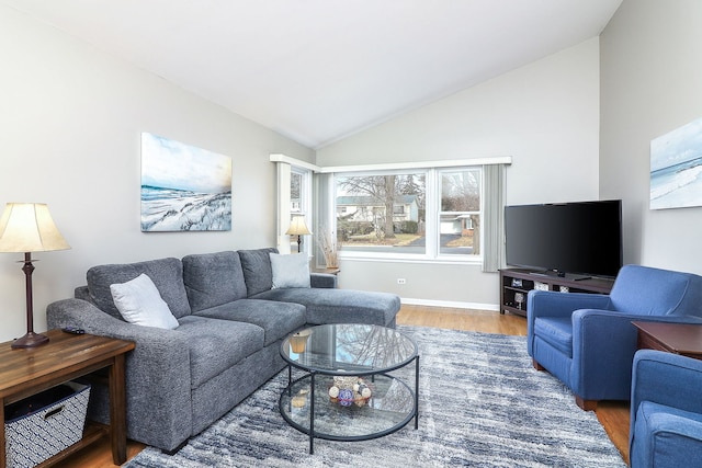 living room featuring vaulted ceiling and hardwood / wood-style floors