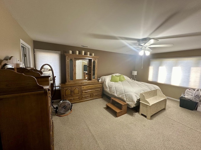 bedroom with light colored carpet and ceiling fan