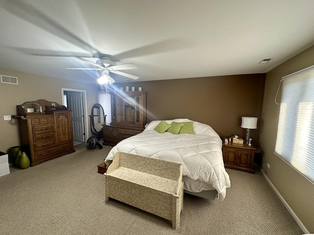 bedroom with ceiling fan and light carpet