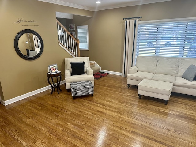 living room with hardwood / wood-style flooring and crown molding