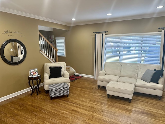 living room featuring hardwood / wood-style flooring and crown molding