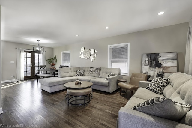 living room featuring french doors, dark hardwood / wood-style floors, and a chandelier