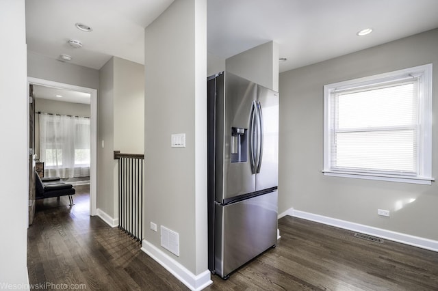 kitchen featuring dark wood-type flooring and stainless steel fridge with ice dispenser