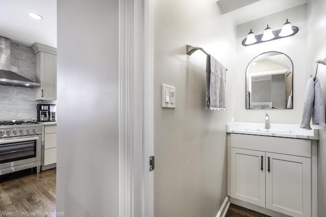 bathroom with vanity, decorative backsplash, and wood-type flooring