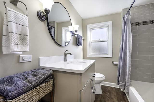 full bathroom featuring hardwood / wood-style flooring, vanity, shower / bath combination with curtain, and toilet