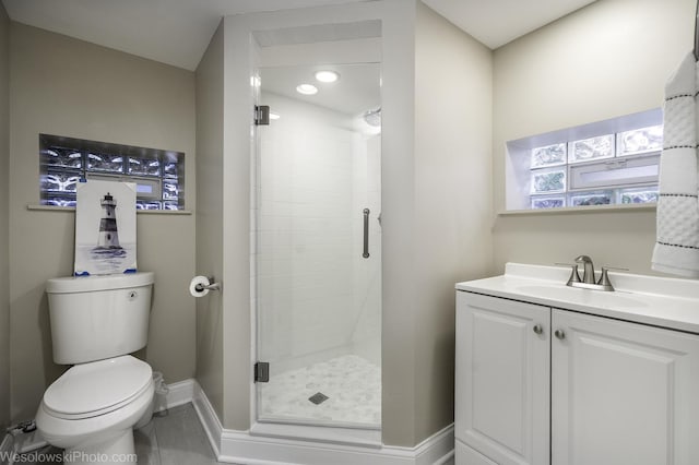 bathroom with vanity, toilet, and a shower with shower door