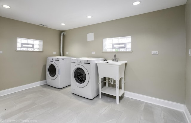 washroom with a wealth of natural light and washer and clothes dryer