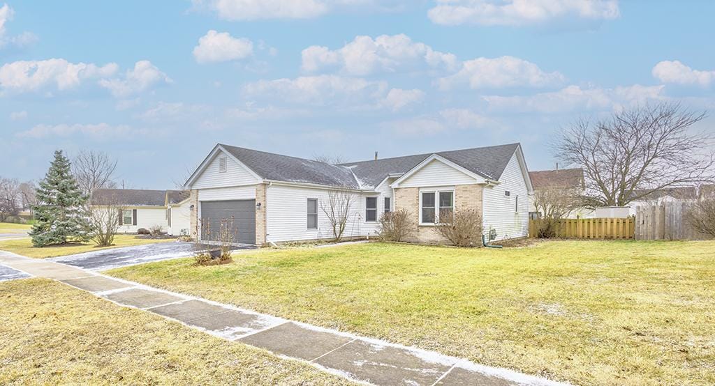 view of front of home with a garage and a front lawn