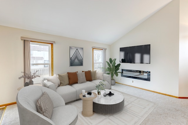 carpeted living room featuring lofted ceiling