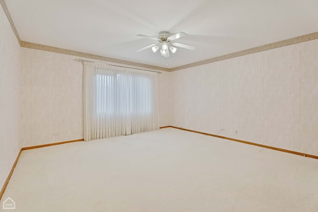 carpeted empty room featuring ceiling fan