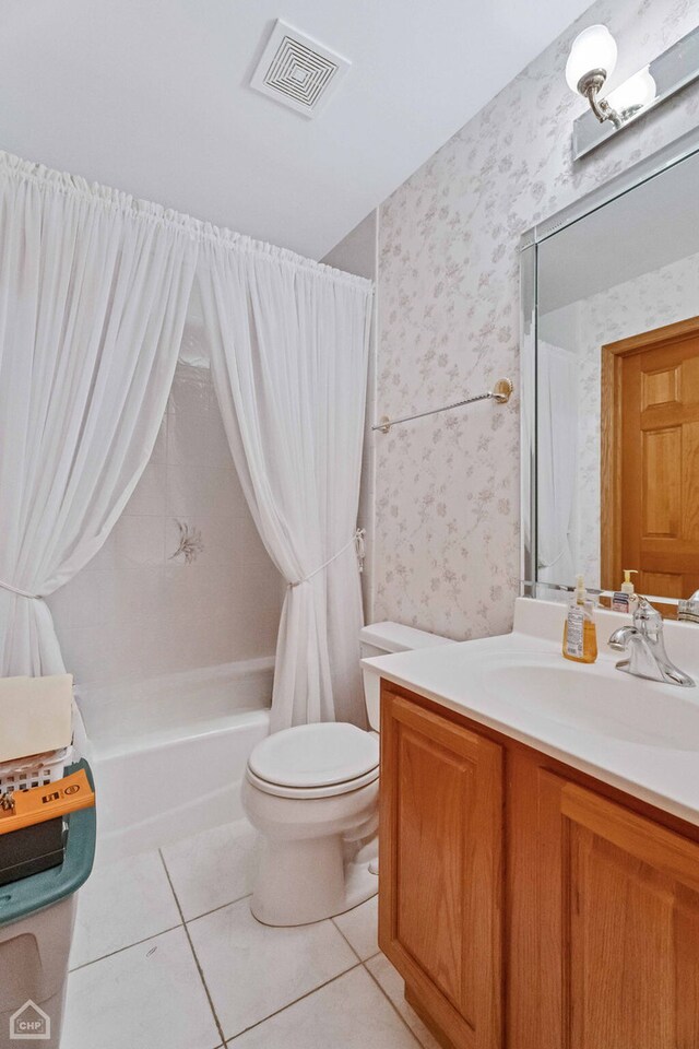 full bathroom with shower / tub combo with curtain, tile patterned floors, toilet, and vanity