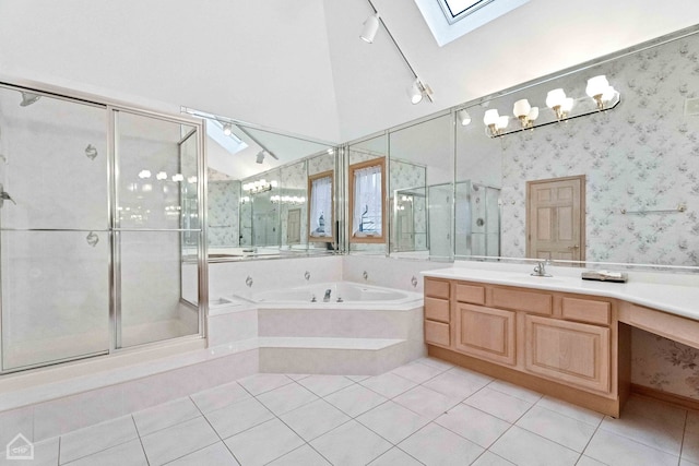 bathroom with vanity, tile patterned flooring, lofted ceiling with skylight, and separate shower and tub