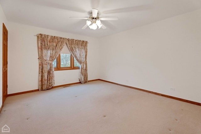 carpeted spare room with ceiling fan