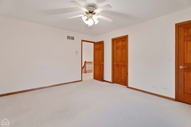 unfurnished bedroom featuring ceiling fan and light carpet