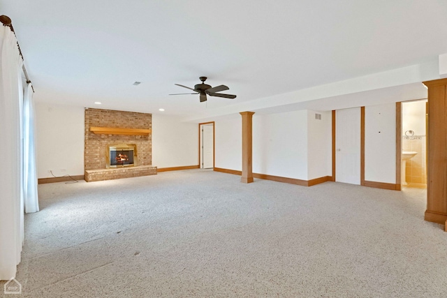 unfurnished living room with ceiling fan, light colored carpet, and a fireplace