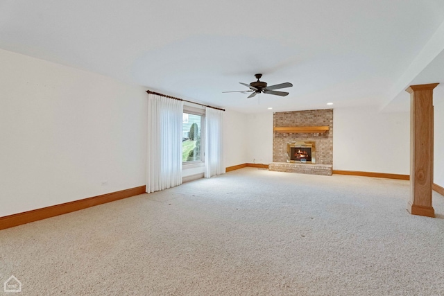 unfurnished living room with light carpet, a brick fireplace, and ceiling fan