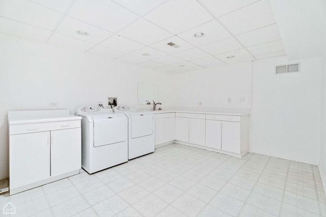 laundry room featuring cabinets, sink, and washing machine and dryer