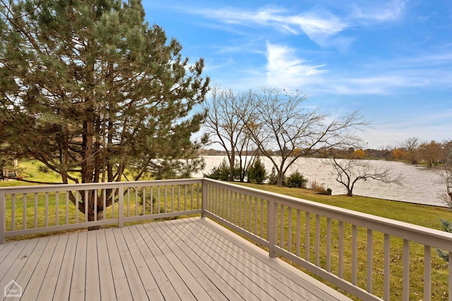 wooden terrace featuring a water view and a yard