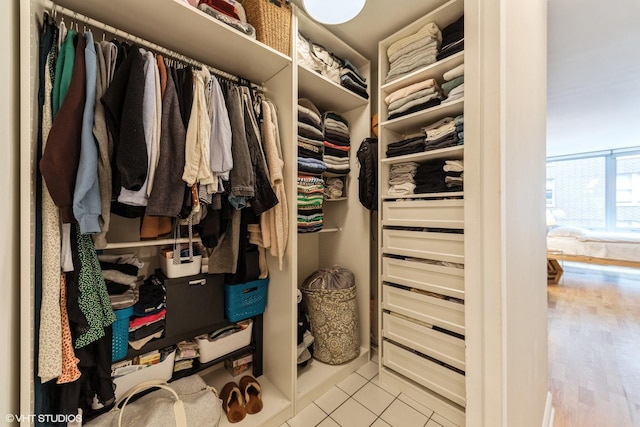 walk in closet with light tile patterned floors