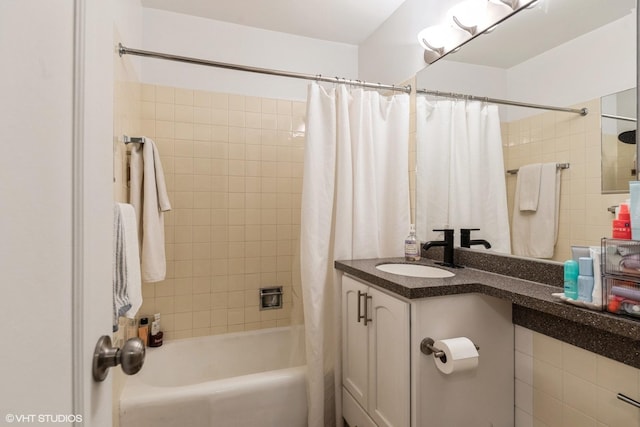 bathroom featuring vanity and shower / bathtub combination with curtain