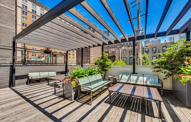 wooden deck with an outdoor hangout area and a pergola