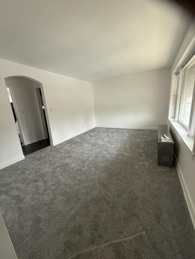 empty room featuring dark colored carpet