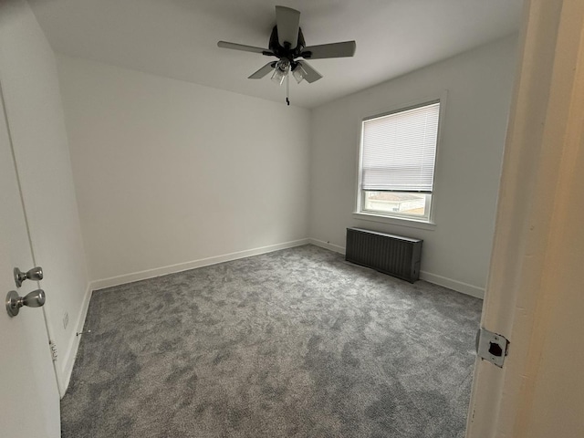 carpeted spare room with radiator heating unit and ceiling fan