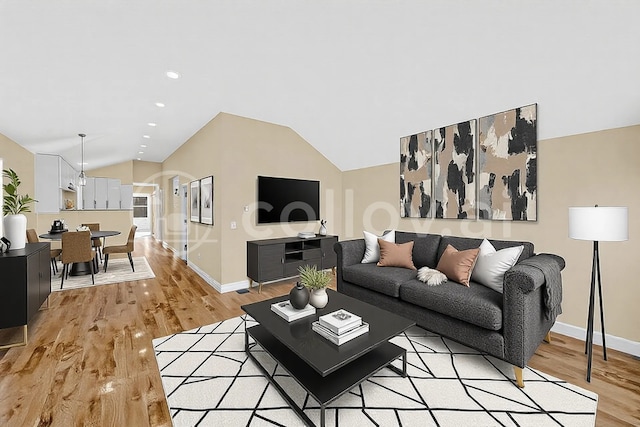 living room featuring lofted ceiling and light hardwood / wood-style flooring