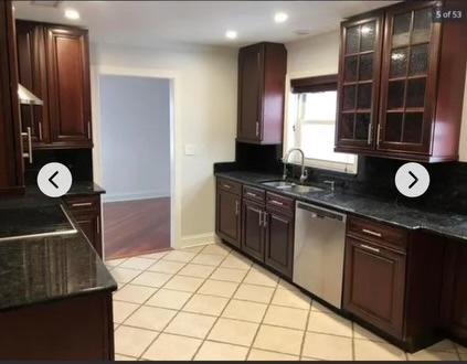 kitchen with sink, decorative backsplash, black electric stovetop, stainless steel dishwasher, and light tile patterned floors