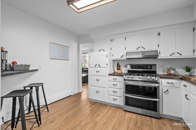 kitchen featuring white cabinetry, double oven range, light hardwood / wood-style floors, and a baseboard heating unit