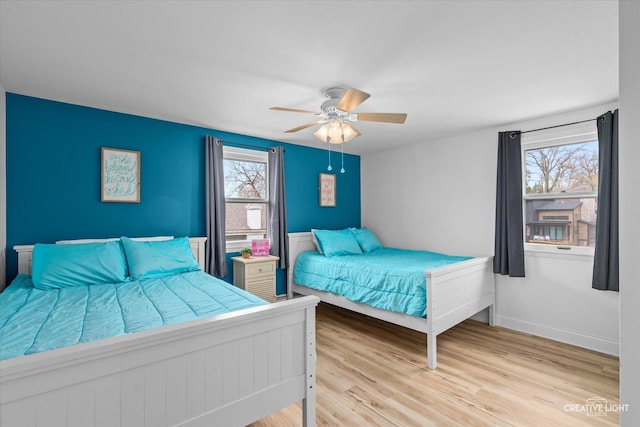 bedroom featuring light hardwood / wood-style flooring and ceiling fan